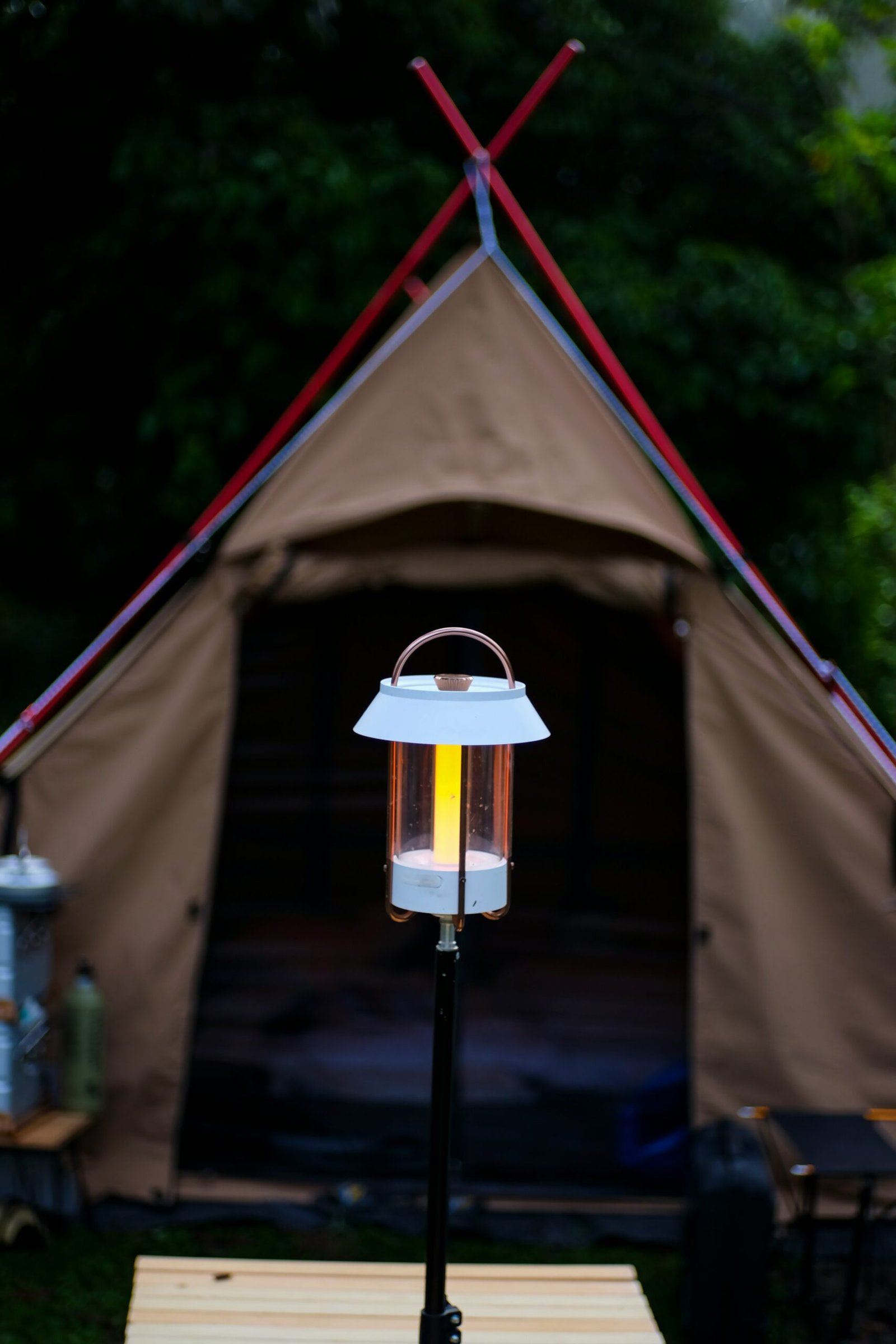 a lit lantern sitting on top of a wooden table