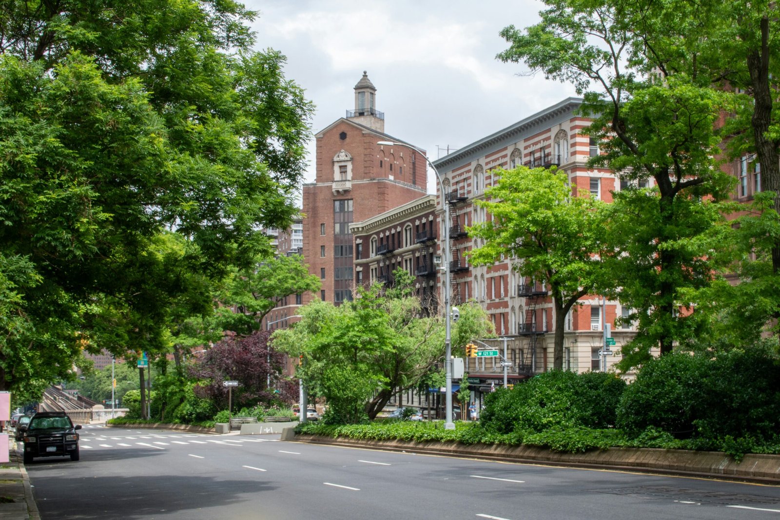 A view of a city street with a clock tower in the background